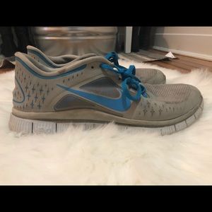 Blue and Gray Nike Free tennis shoes